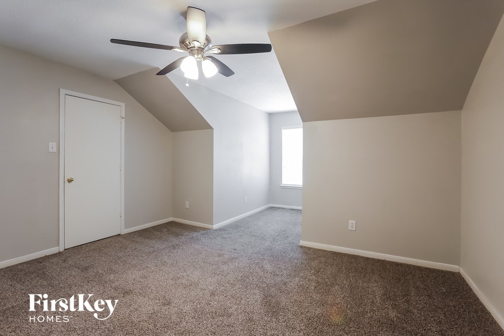 a bedroom with carpet and a ceiling fan