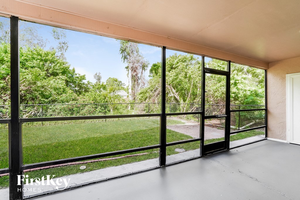 a balcony with a view of a yard and trees