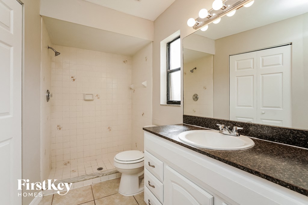 a white bathroom with a sink and a toilet