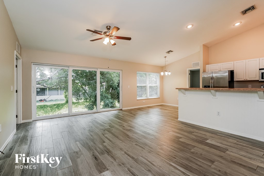 the living room is open to the kitchen and dining room