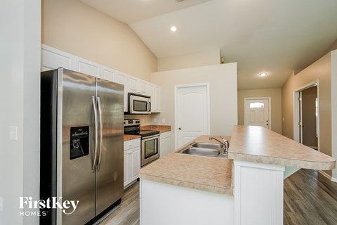 a kitchen with stainless steel appliances and white cabinets