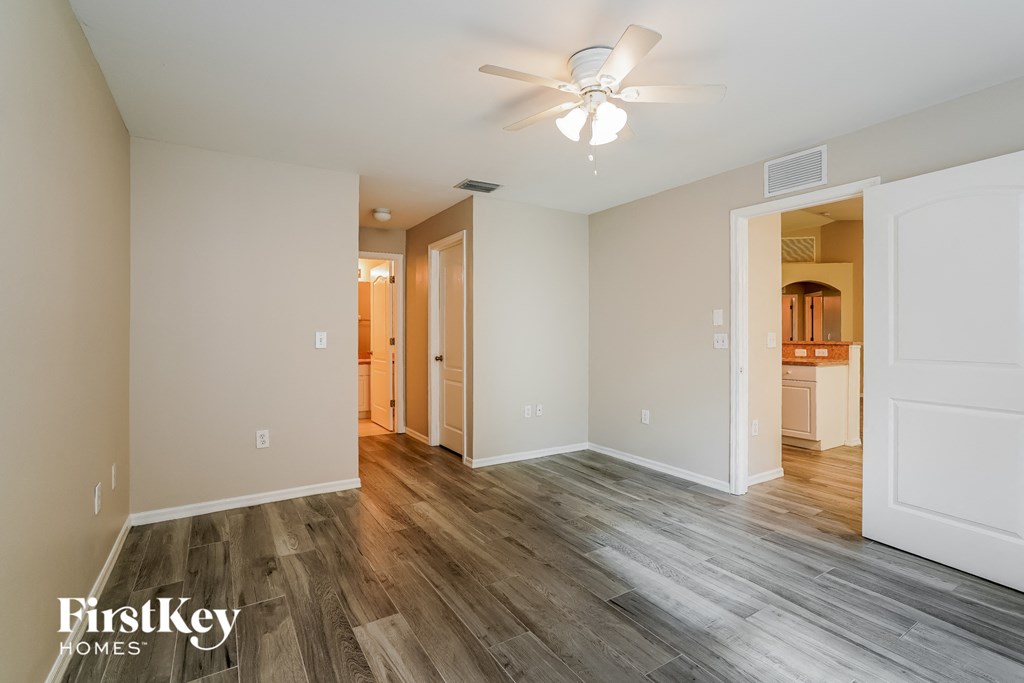 a renovated living room with wood flooring and a ceiling fan