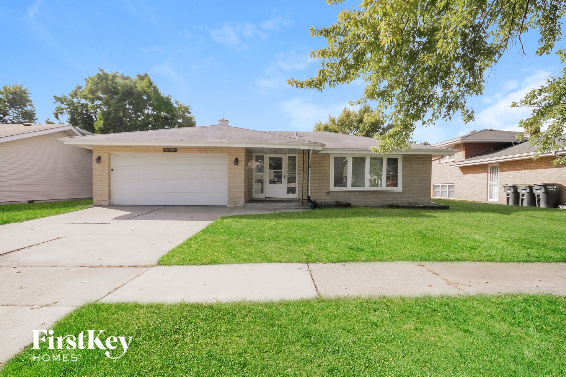 a home with a lawn and a driveway