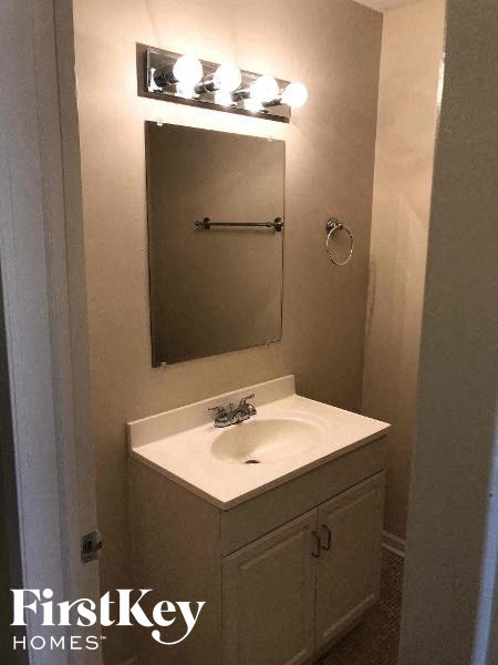 a small bathroom with a sink and a mirror