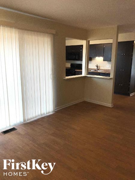 an empty living room with a wood floor