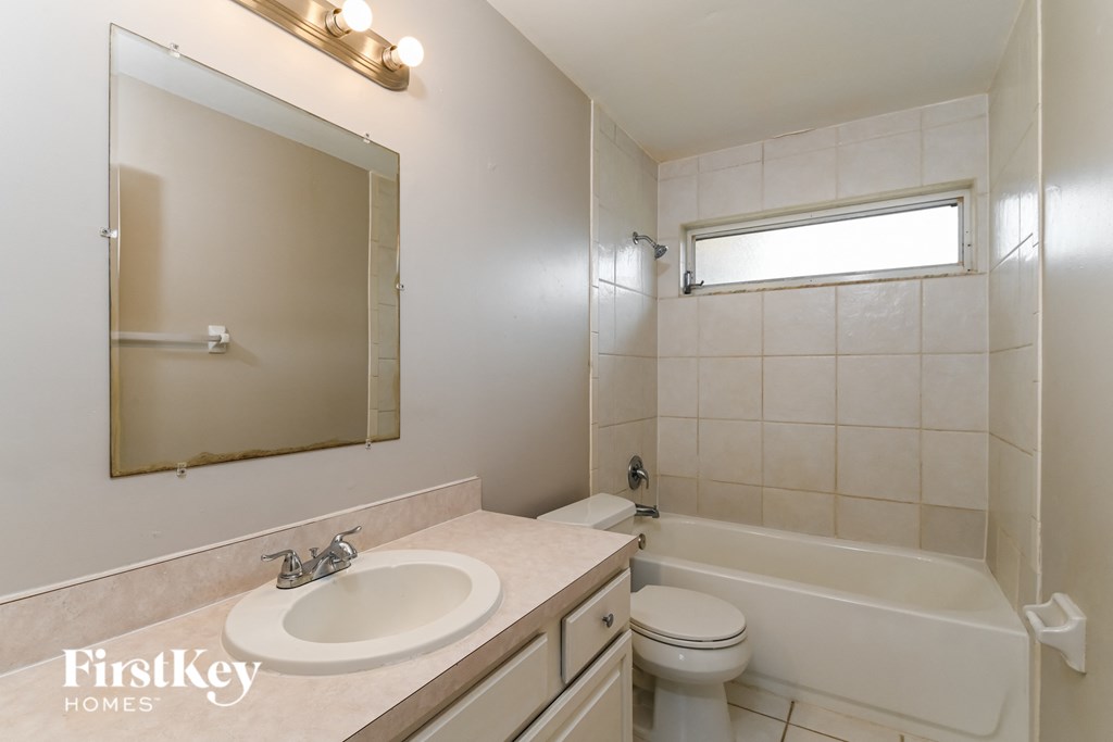 a bathroom with a sink and a toilet and a bath tub
