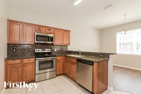 A kitchen with wooden cabinets and stainless steel appliances.