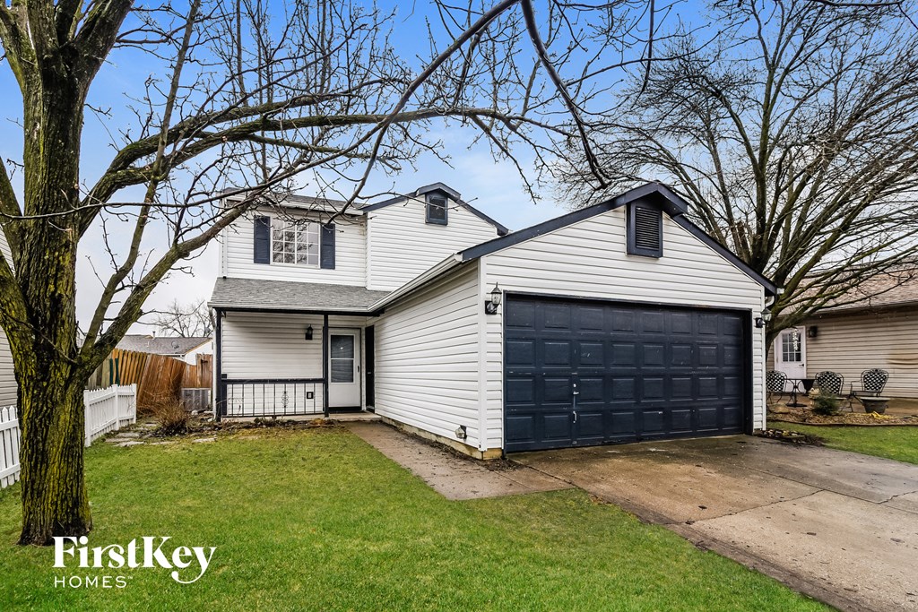a white house with a black garage door
