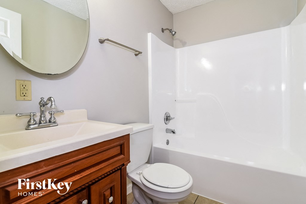 a bathroom with a sink toilet and a tub
