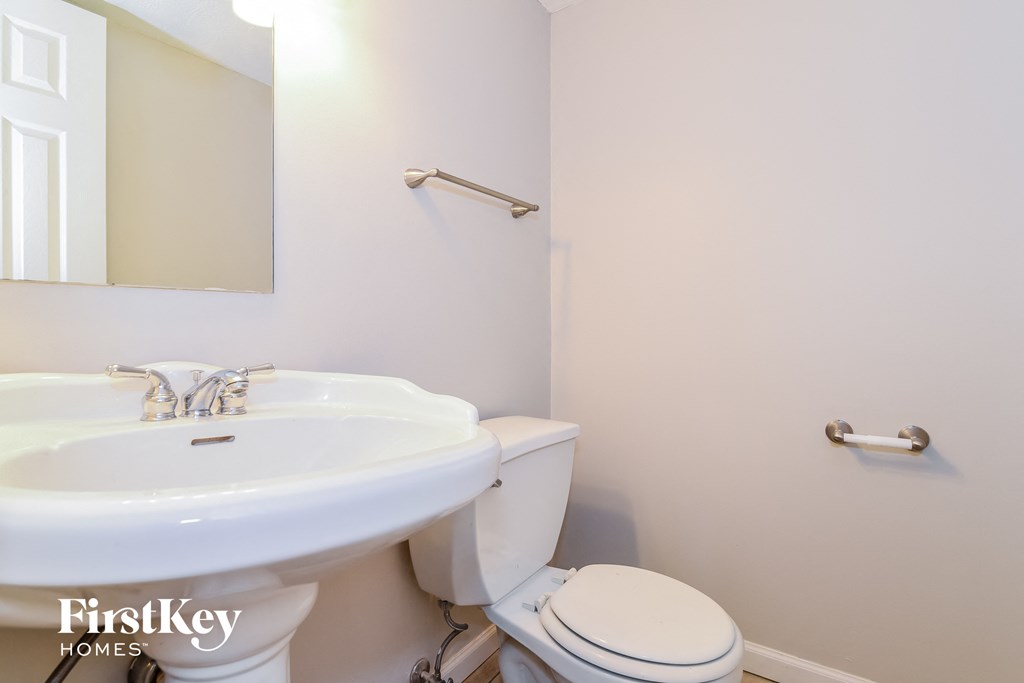 a bathroom with a sink and a toilet and a mirror