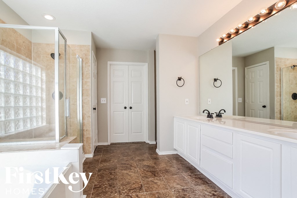 a large white bathroom with a large mirror and a sink