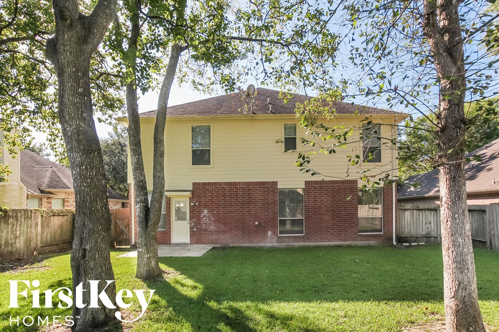 a yellow house with trees in front of it