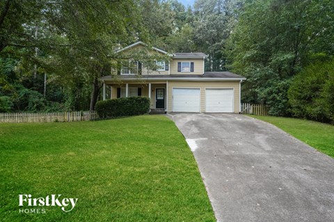 A house with a driveway in front of it.