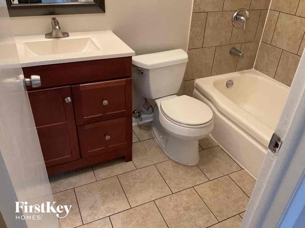 a bathroom with a sink toilet and bath tub