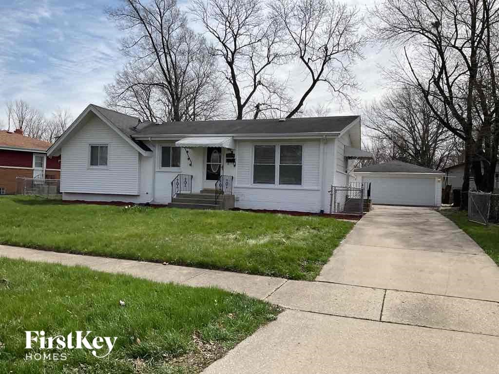 a white house with a sidewalk in front of it