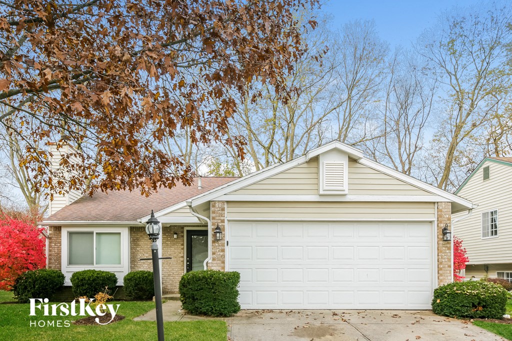 A house with a white garage door is for sale.
