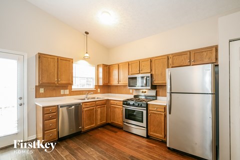 A kitchen with wooden cabinets and stainless steel appliances.