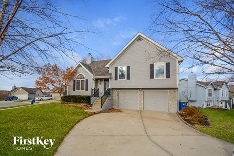 a white house with a driveway and a garage door