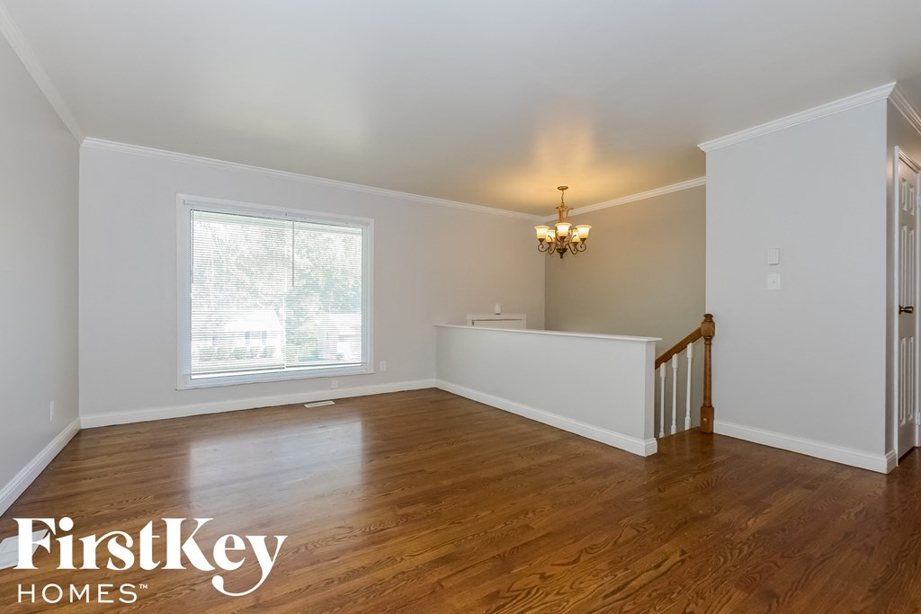 A room with wooden floors and a chandelier.