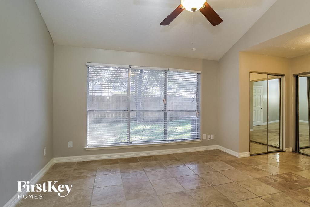 the living room of an empty house with a large window