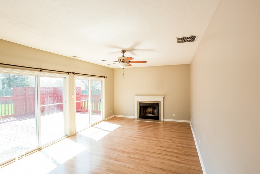 A room with a fireplace and sliding glass doors.