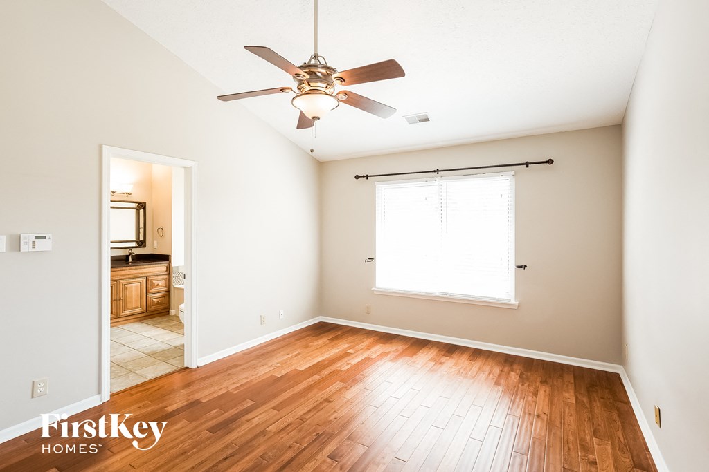 A room with a ceiling fan and a window.