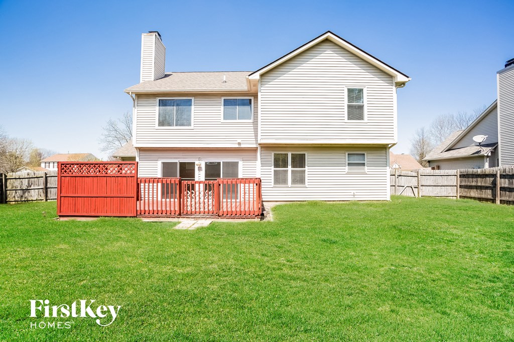A house with a red fence in front of it.