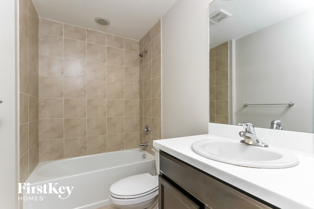 a bathroom with a sink and a toilet and a bath tub