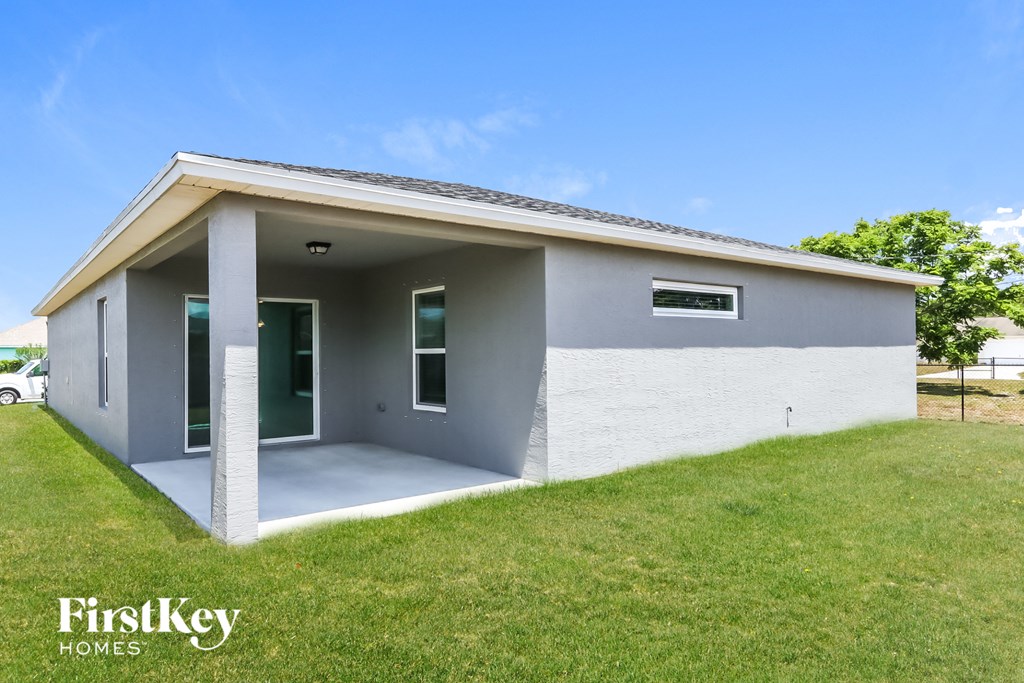 a small gray and with a lawn and a blue sky