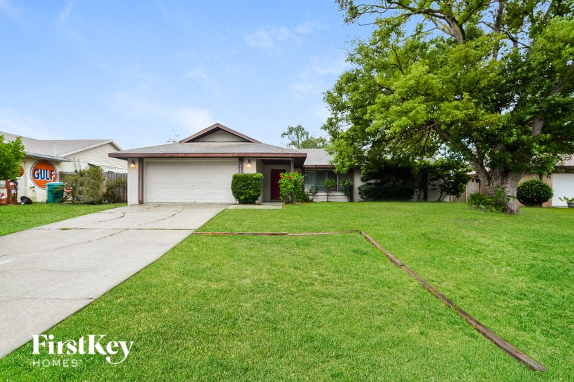 a home with a lawn and a white garage door