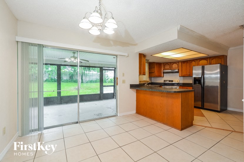 a kitchen with a sliding glass door leading to the patio