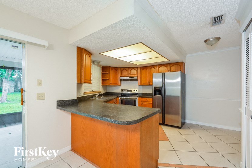 a kitchen with stainless steel appliances and granite counter tops