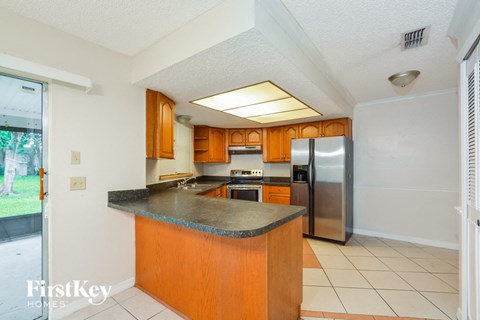 a kitchen with stainless steel appliances and granite counter tops