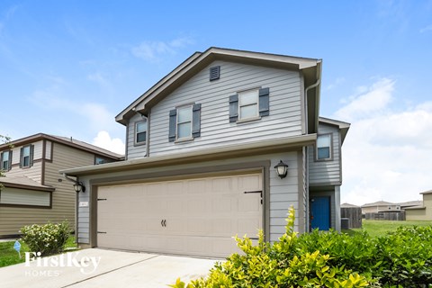 a gray house with a white garage door