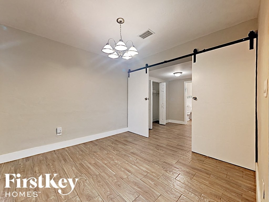 the living room is open to the dining room and kitchen through a sliding barn door