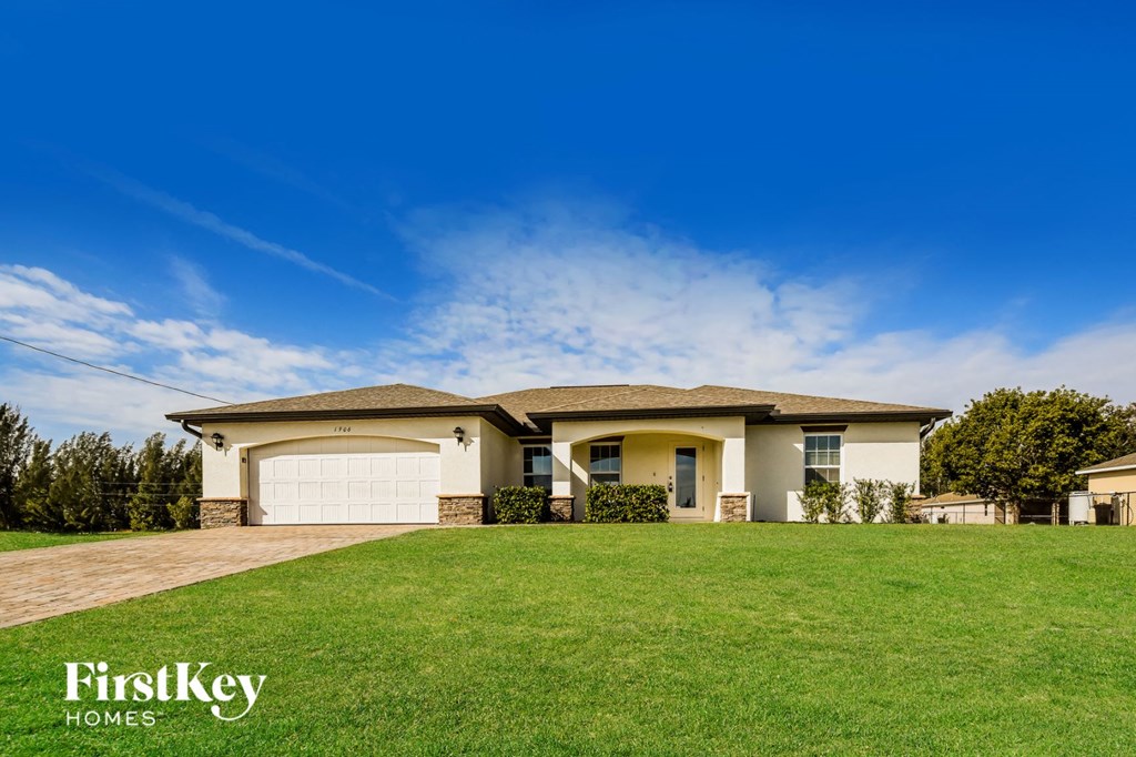 A house with a garage and a driveway is shown.