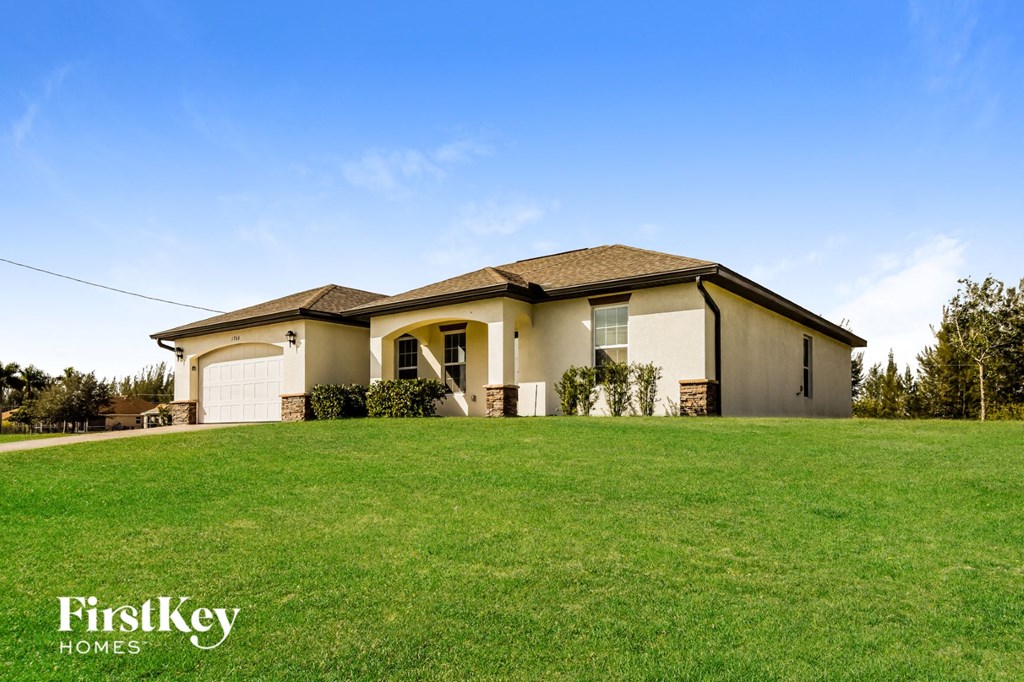 A house with a lawn in front of it and the words "FirstKey Homes" on the bottom.