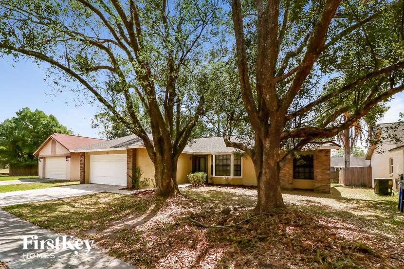 a house with two trees in front of it