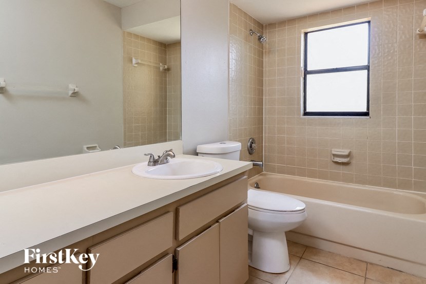 a bathroom with a sink toilet and a bath tub