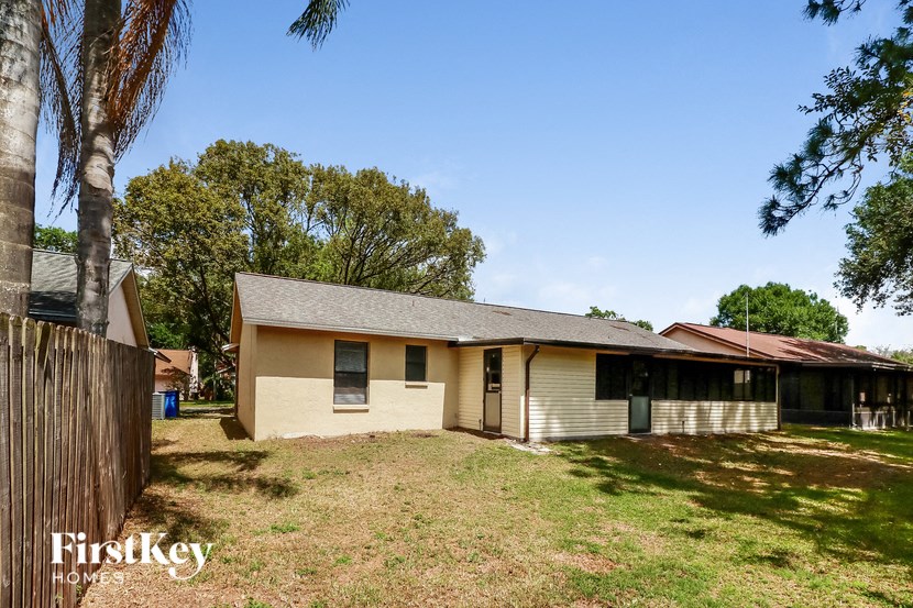 a small house with a yard and a fence