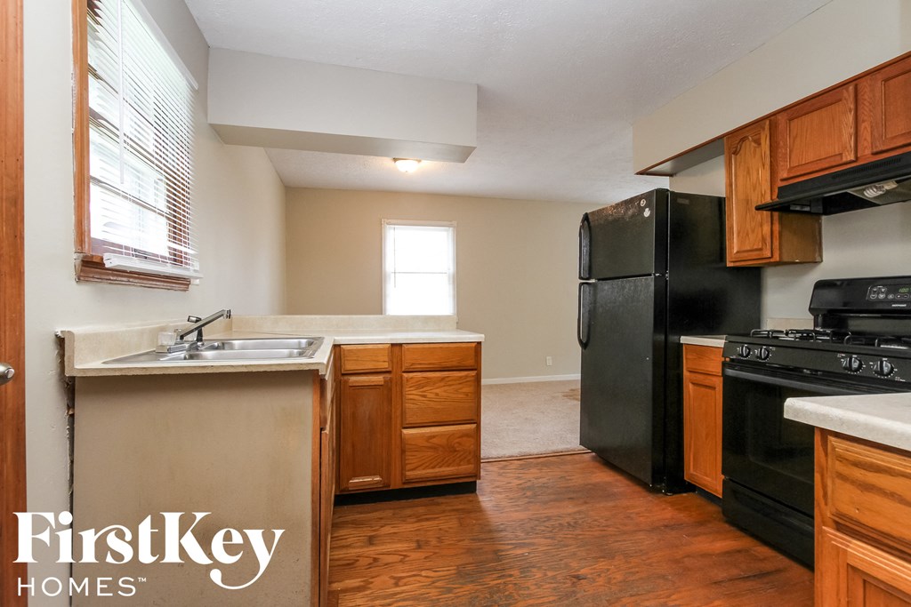 a kitchen with black appliances and wooden cabinets