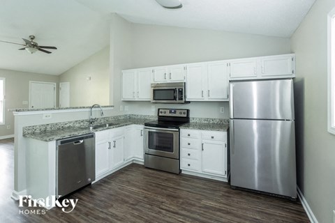 a kitchen with stainless steel appliances and white cabinets