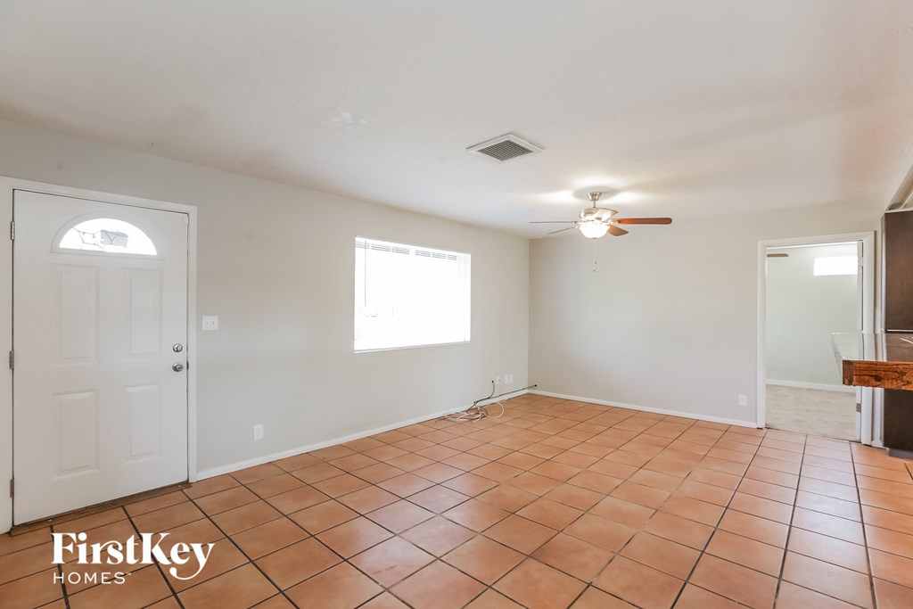 A room with a tiled floor and a ceiling fan.