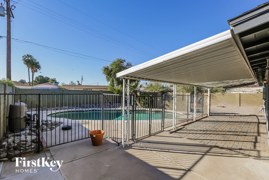 A pool area with a FirstKey Homes sign.