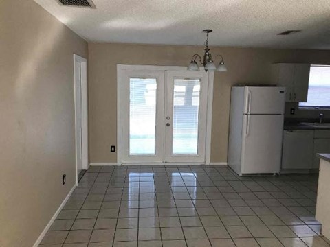 A kitchen with white appliances and a white refrigerator.