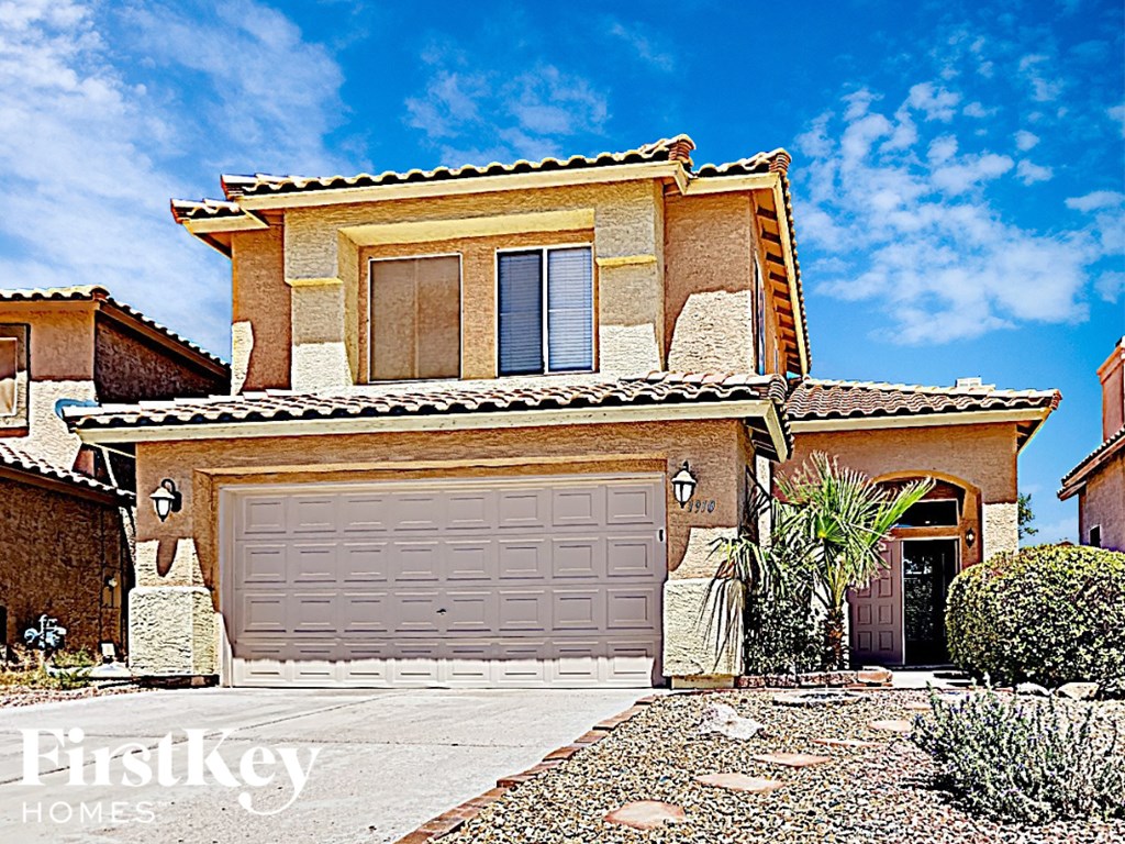 A house with a garage door and a sign that says "FirstKey Homes".