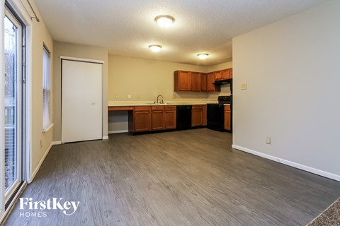 A kitchen with wooden cabinets and a white door.