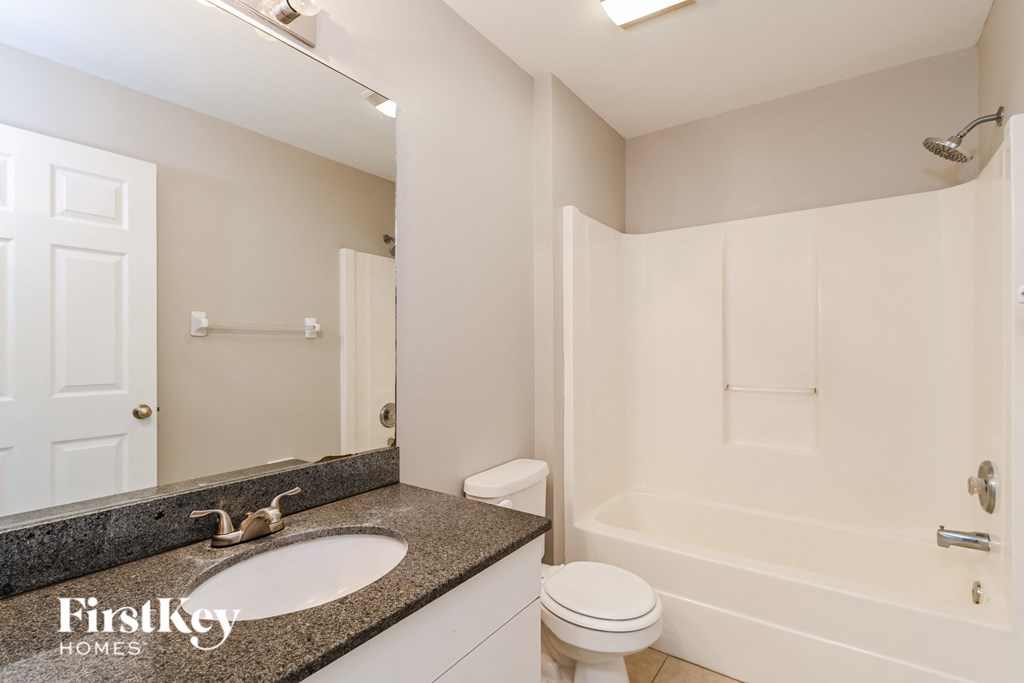 a bathroom with a sink and a shower and a toilet