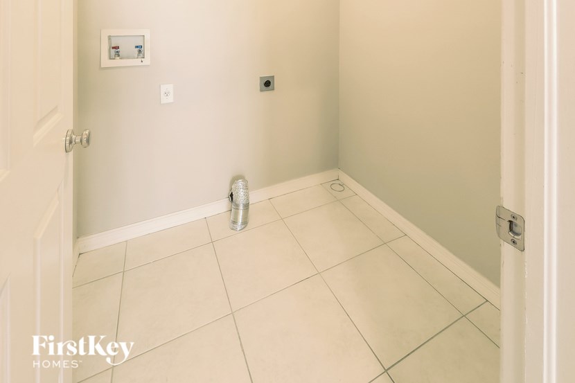 A room with a tile floor and a can of paint on it.