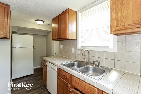 a kitchen with a sink and a refrigerator